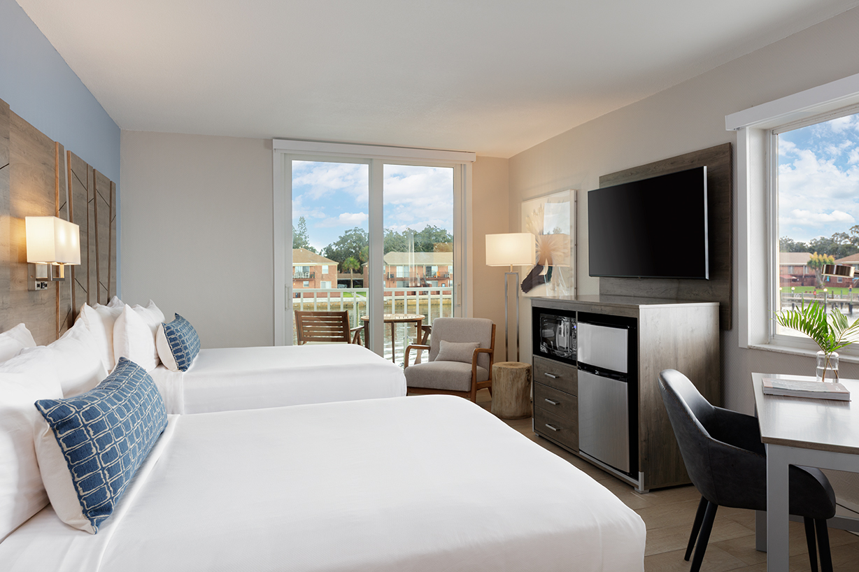 a room with two beds and a television