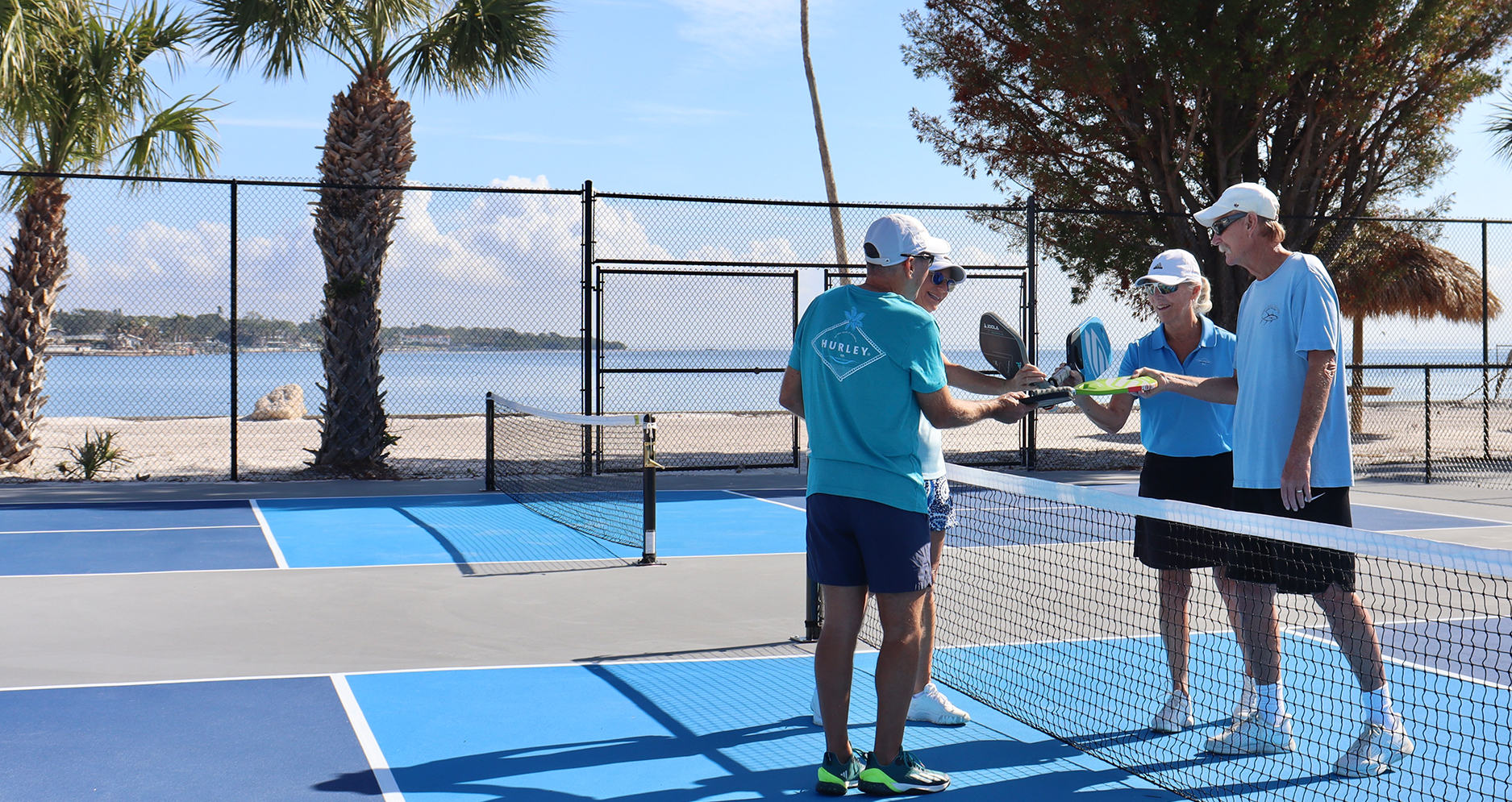 a group of people on a tennis court