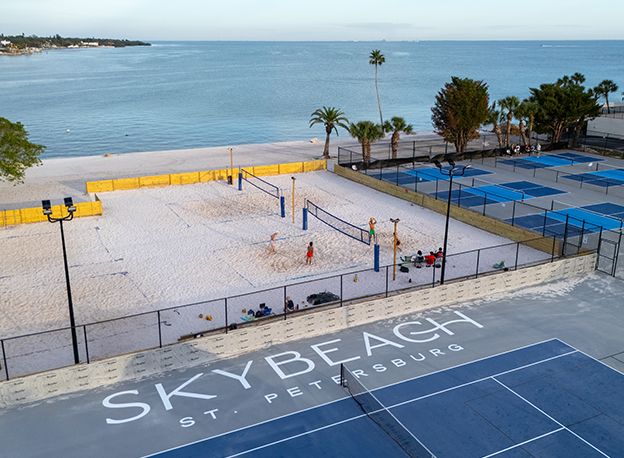 a beach volleyball court with people on it 