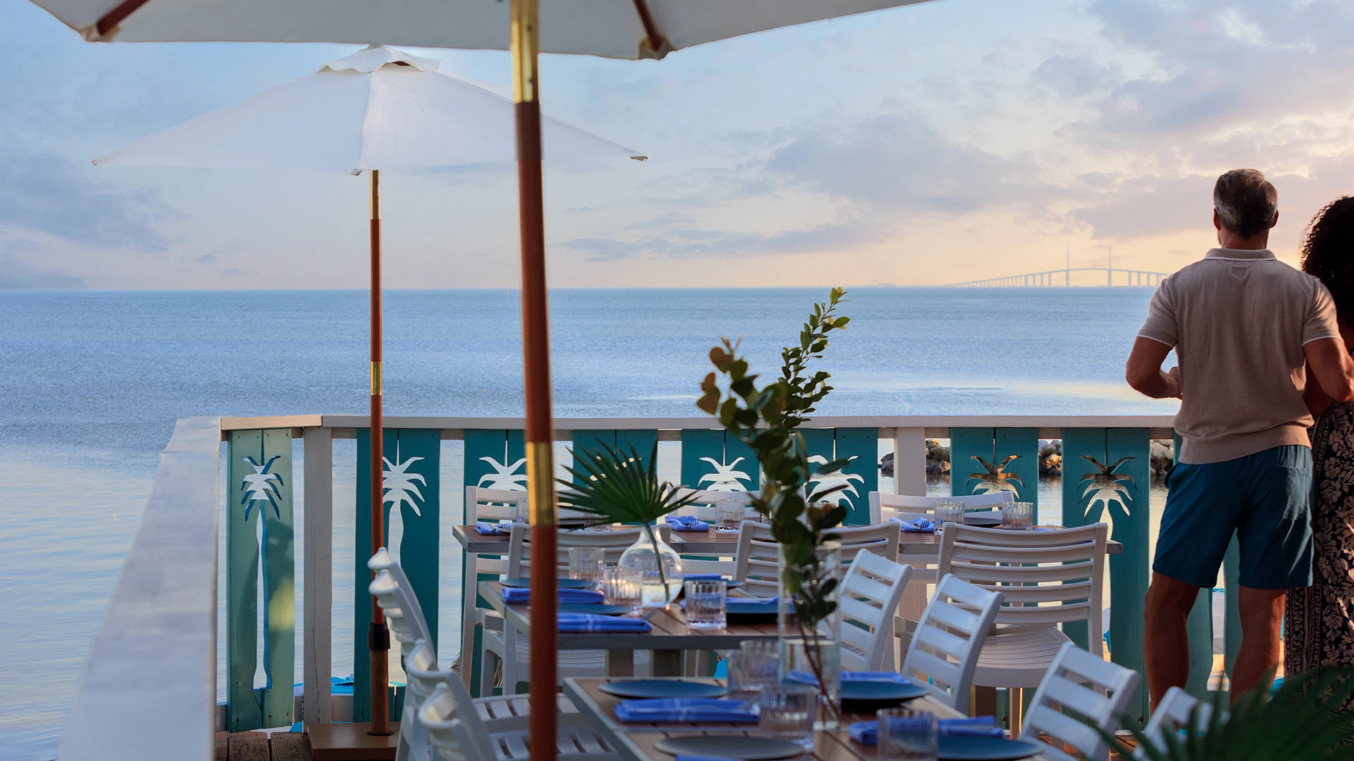 A romantic outdoor dining setup with a beautiful ocean view