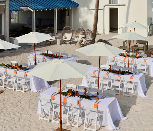 a group of tables and chairs on a beach