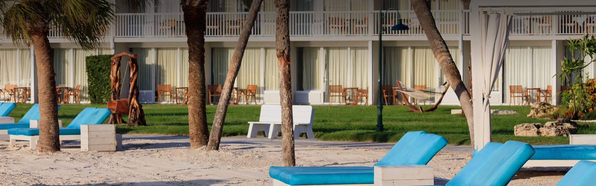 a blue bench in front of a building