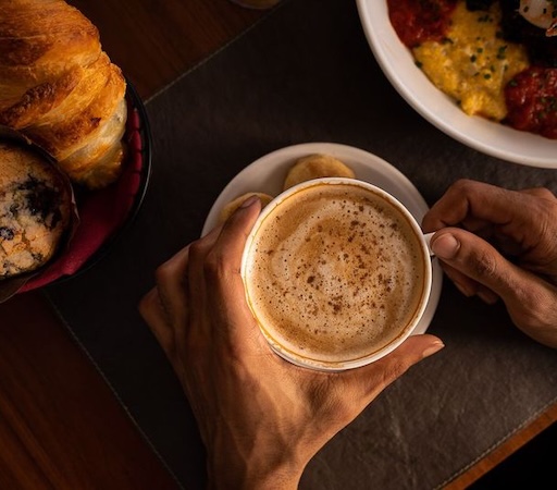 a person holding a cup of coffee