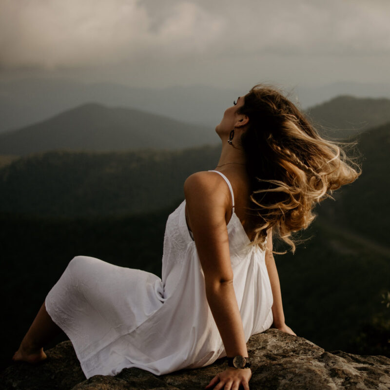 woman wearing a white dress with the mountains in the background