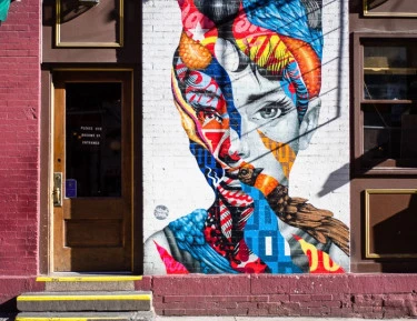 A colorful mural on the side of a building