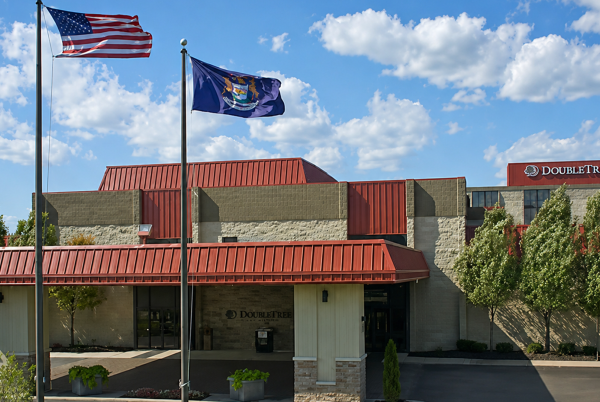 a flag on a flagpole in front of a building
