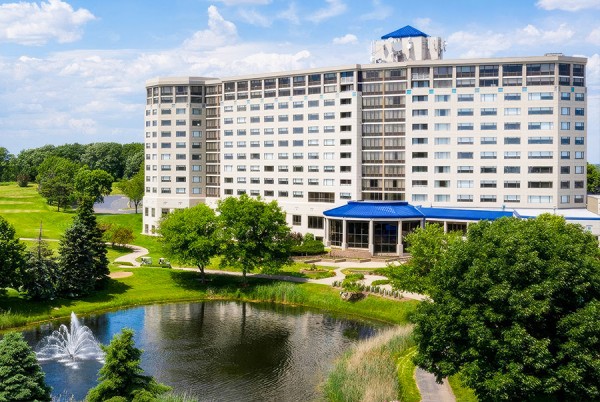 a large building with a pond in front