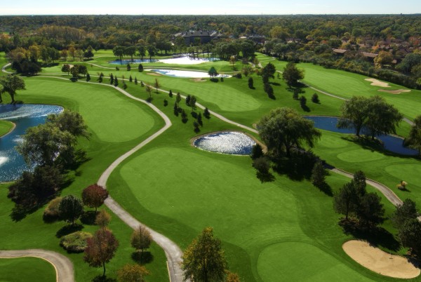 a golf course with water in the middle