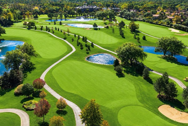 a golf course with water in the middle