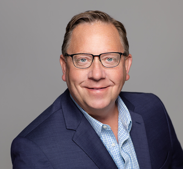 a man in a suit and glasses