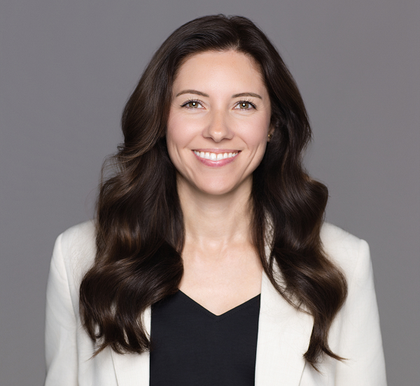 a woman with long brown hair smiling