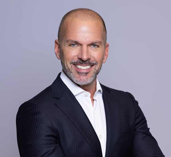 a man in a suit smiling