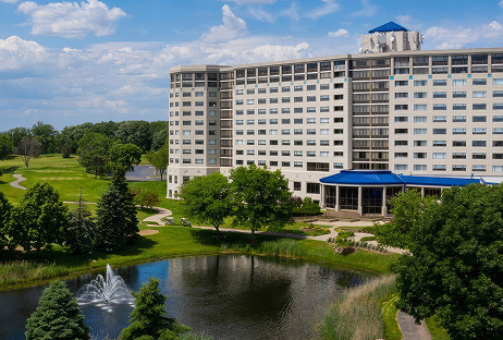 a large building with a pond in front of it