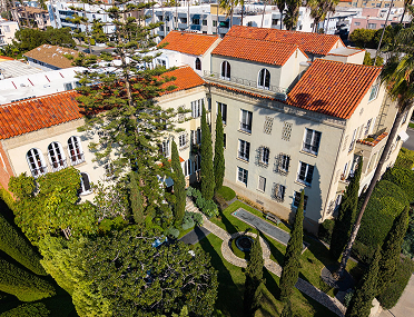 a building with trees and a yard