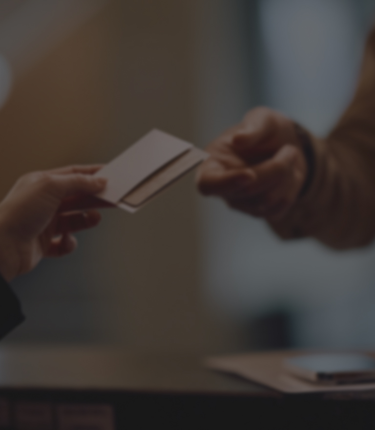 a person handing over a card to another person