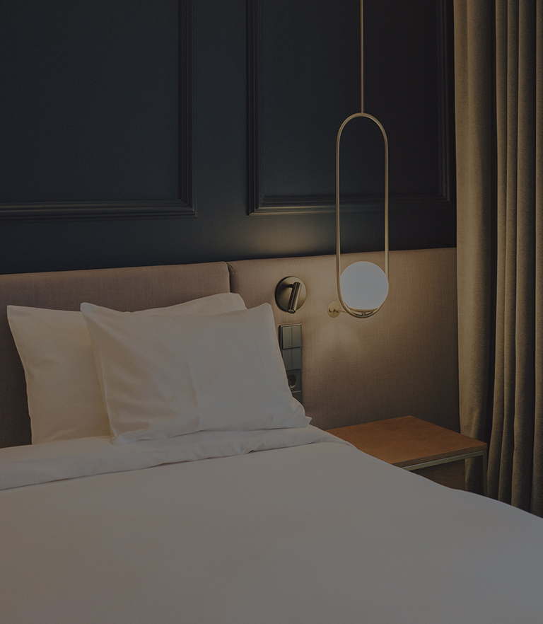 a bed with a lamp and a table