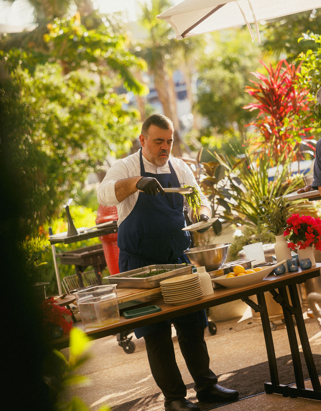 a man in a apron holding a bowl of food