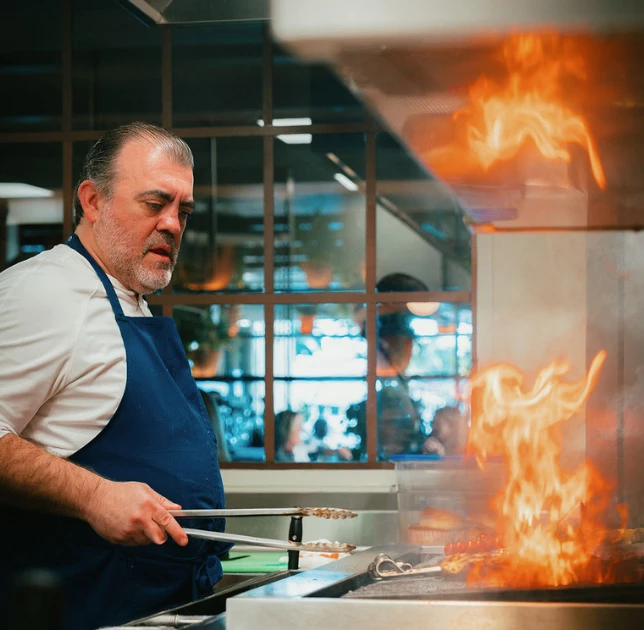 a man cooking food in a kitchen