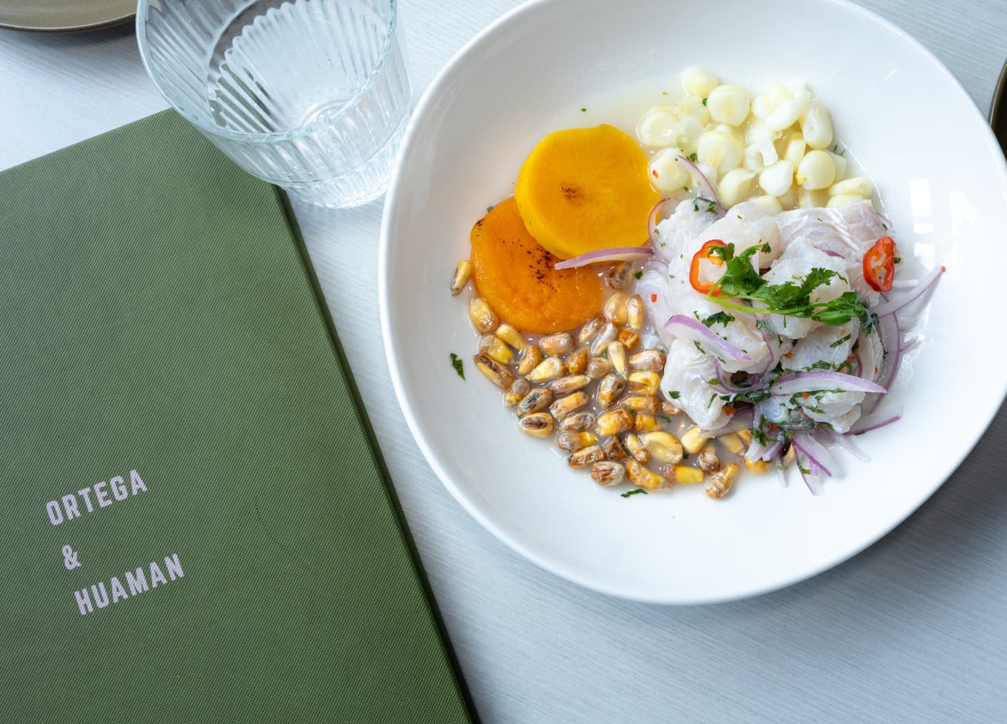 a bowl of food next to a menu