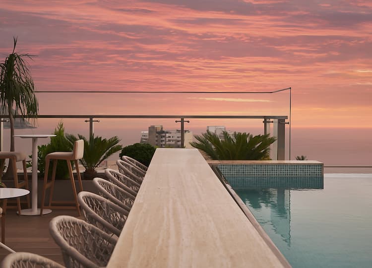 hero image for a pool with chairs and tables on a rooftop
