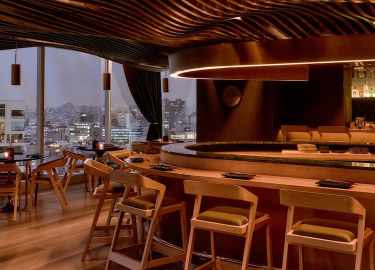 Post image for a room with a large round table and chairs