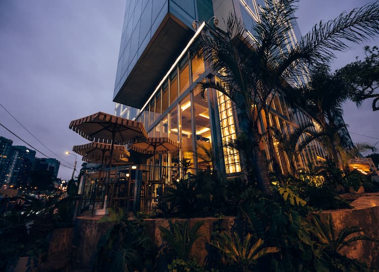 Post image for a building with trees and plants