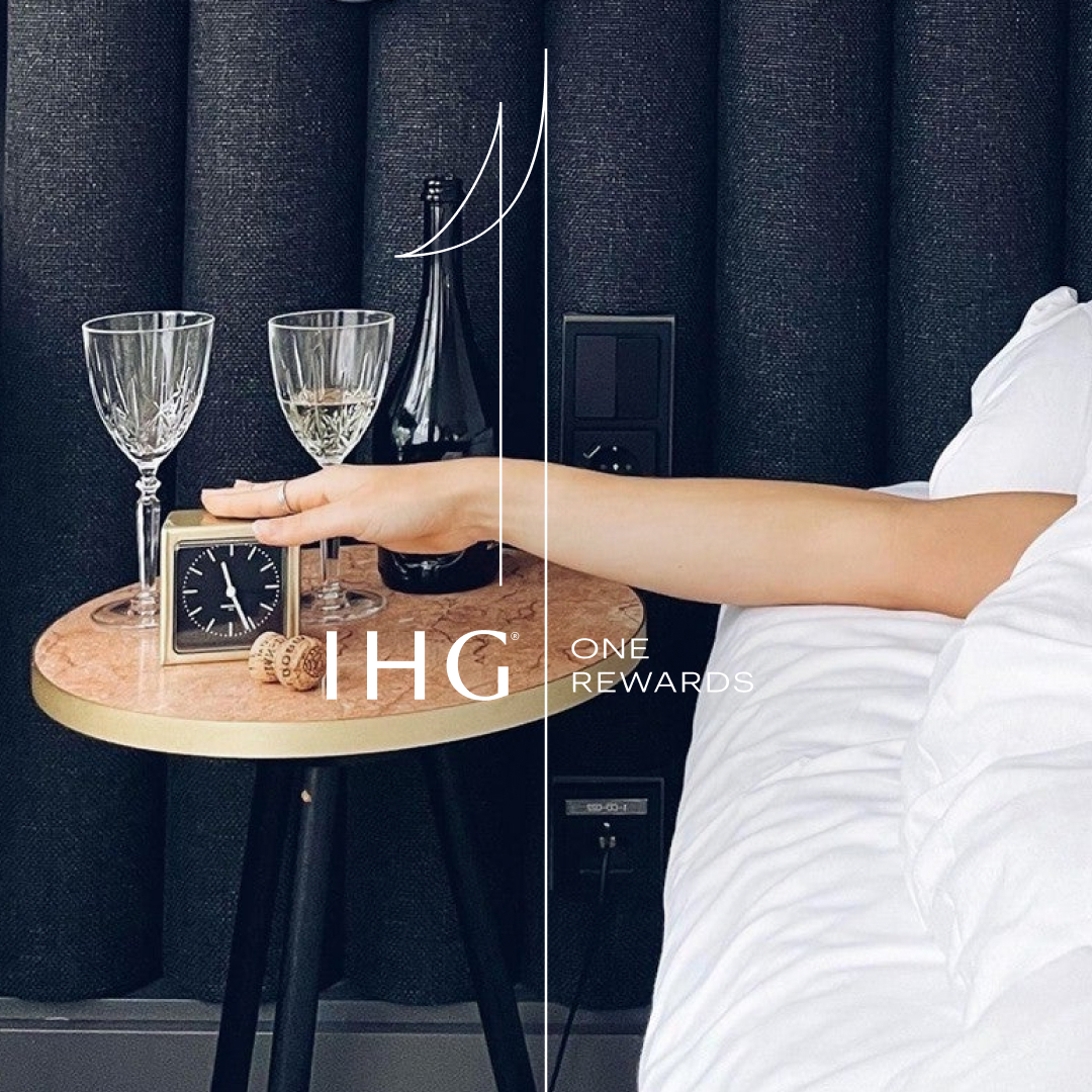 a hand holding a clock on a table