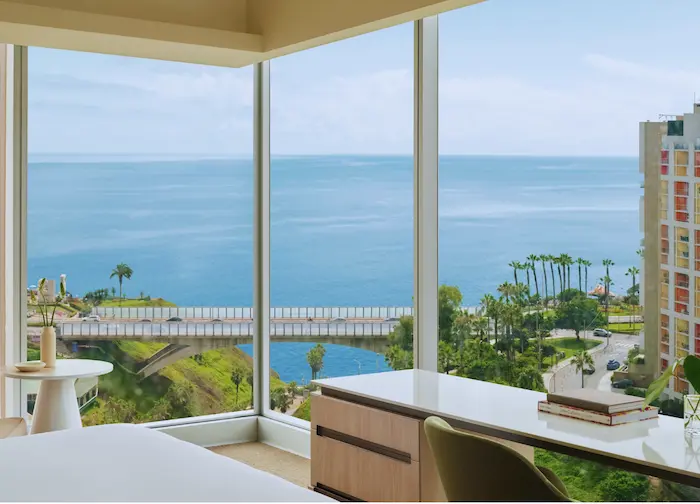 a room with a view of the ocean and a bridge