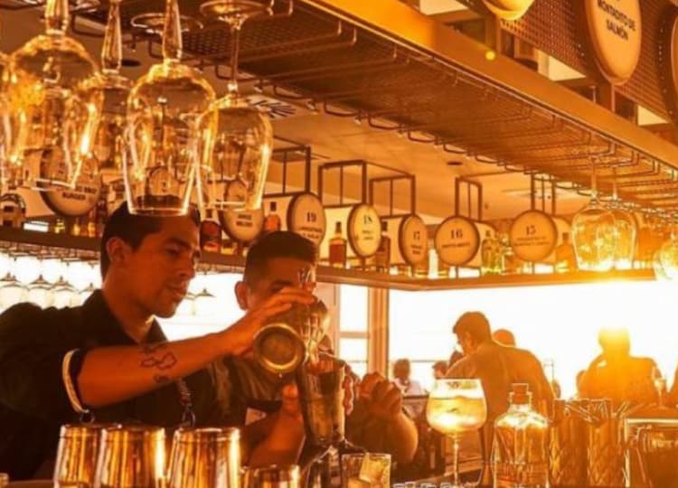 a man pouring a drink into a glass