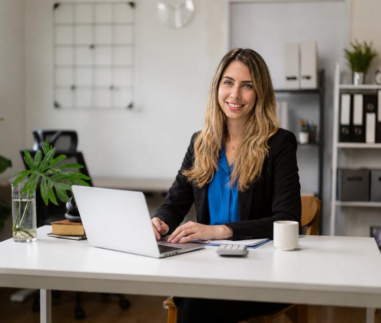 a Laura sitting at a desk with a laptop
