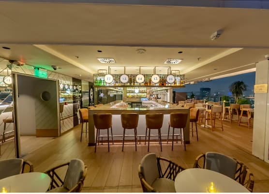 a bar with chairs and tables in a restaurant