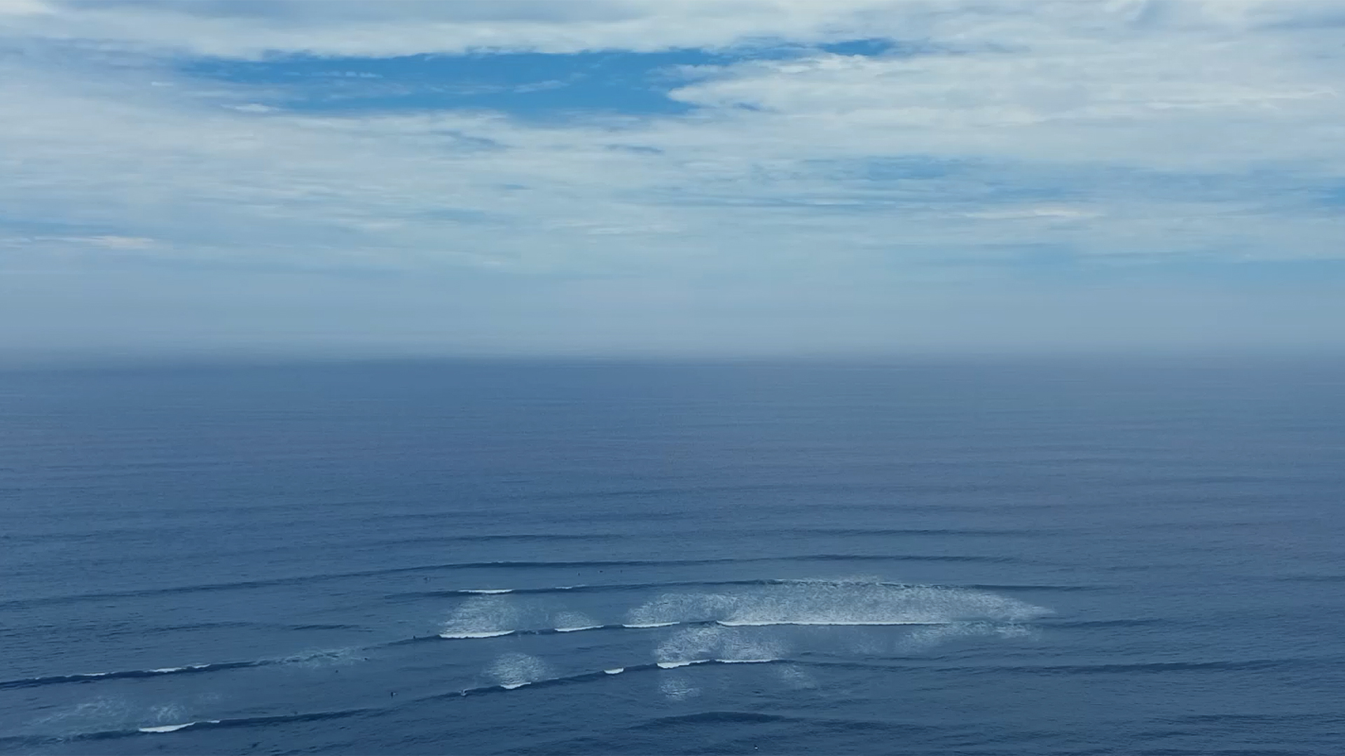 a body of water with clouds in the sky