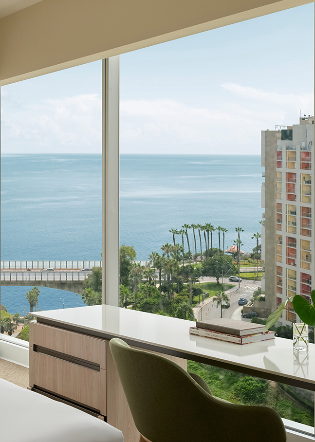 a window with a view of a city and a body of water