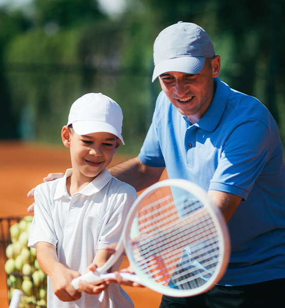 a man and boy playing tennis