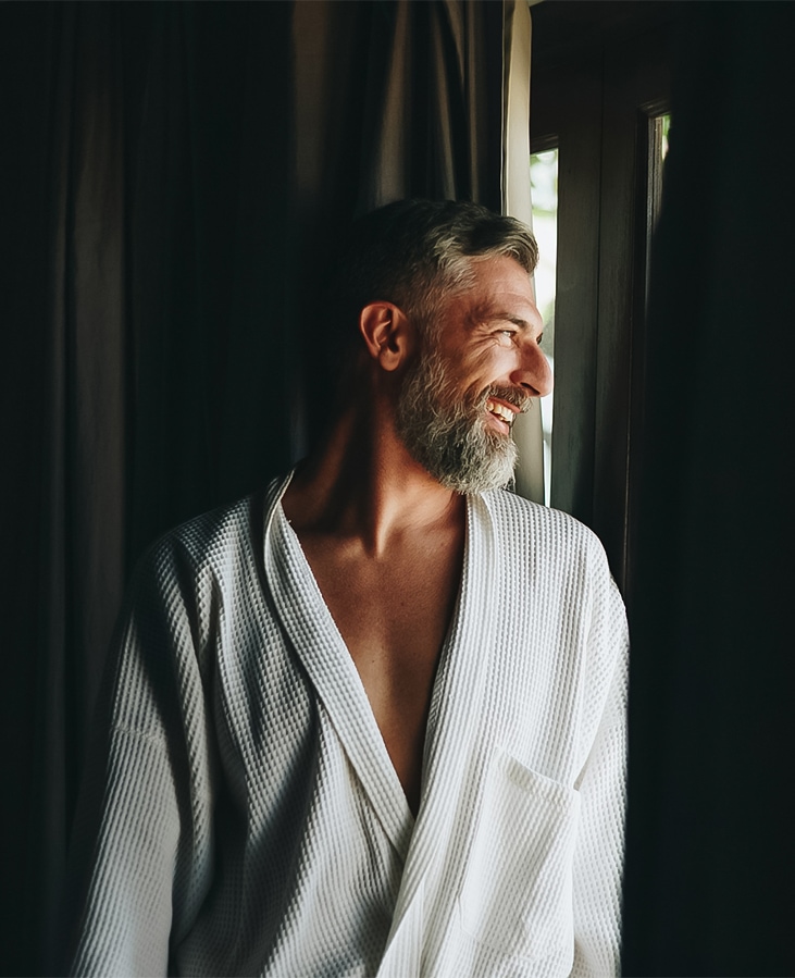 a man in a robe smiling