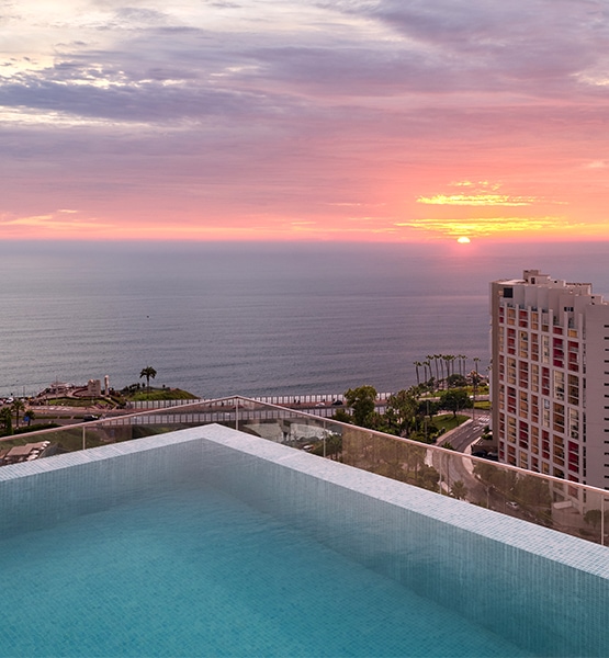 a pool overlooking a city and the ocean