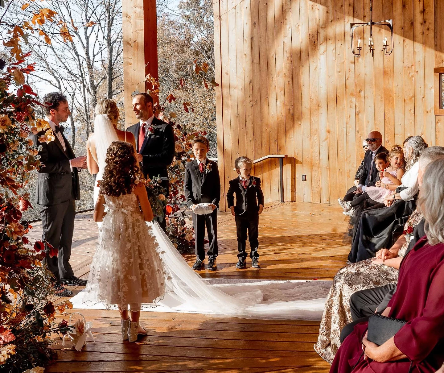 a bride and groom walking down a wooden deck