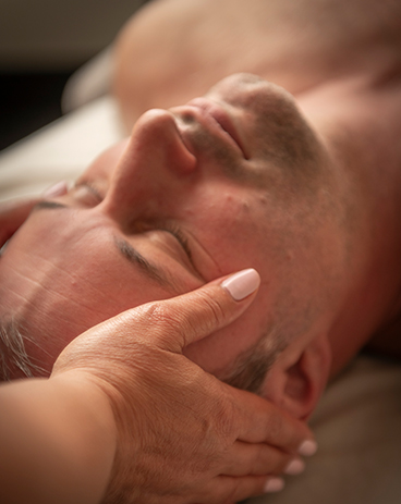 a man lying down with his eyes closed