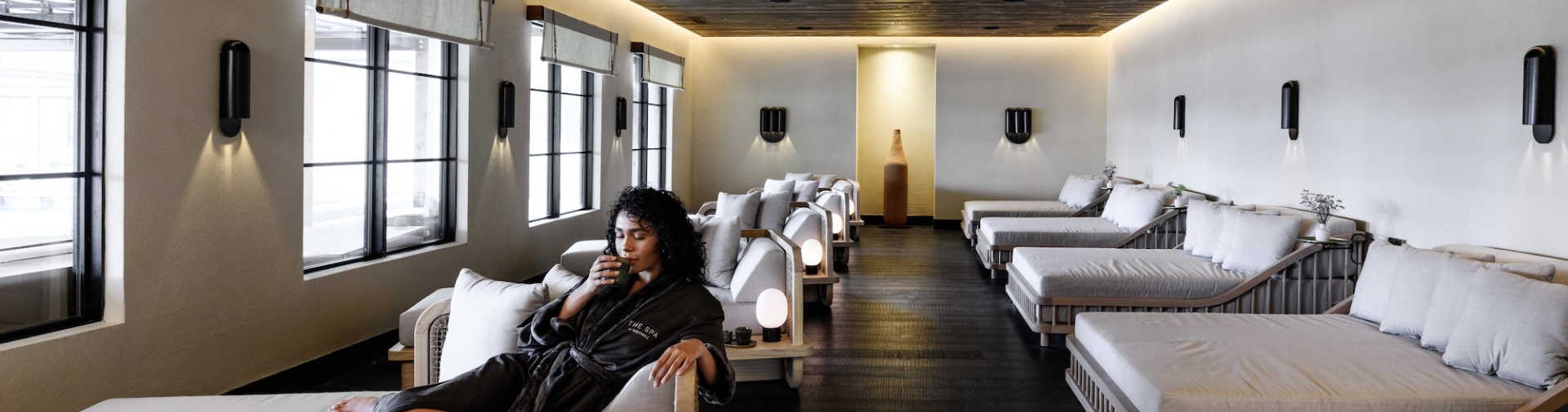 a woman sitting in a chair with a cup in her mouth