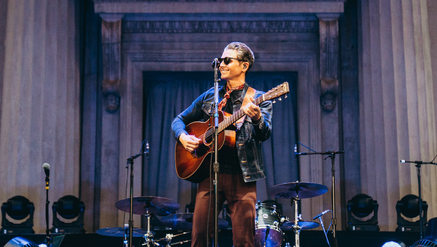 a man playing guitar on stage