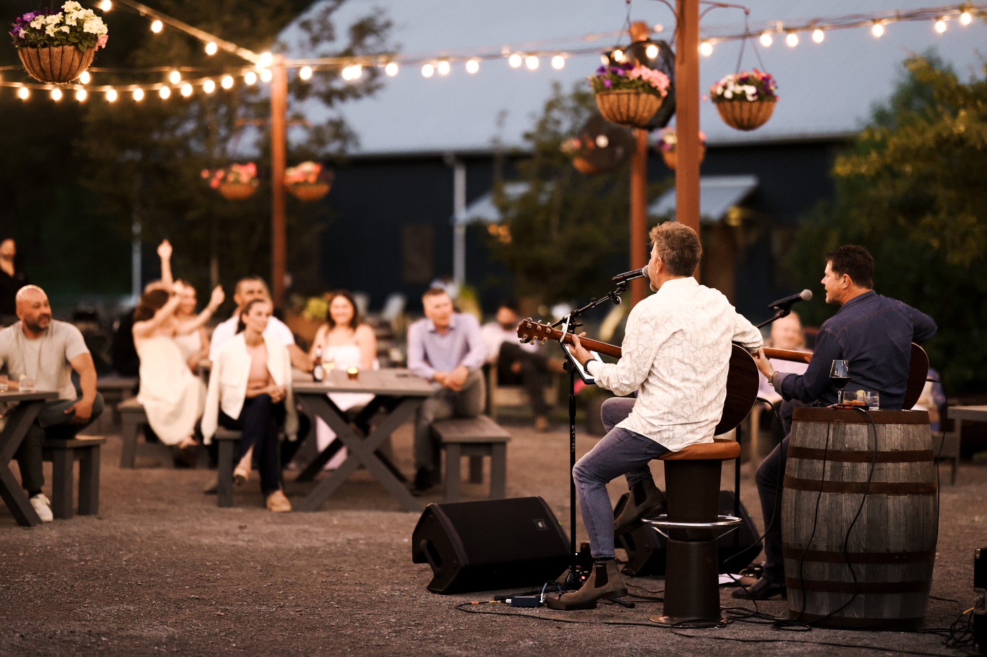 a group of people sitting around a table and playing a guitar