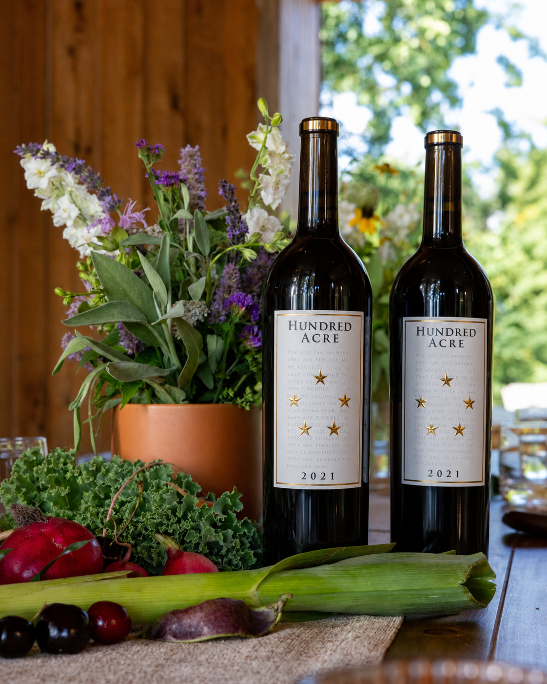 two bottles of wine next to a plant