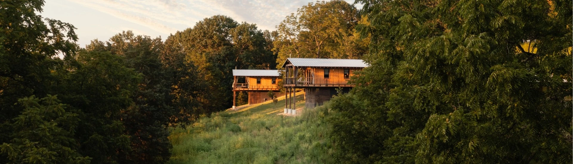 a two wooden houses on a hill