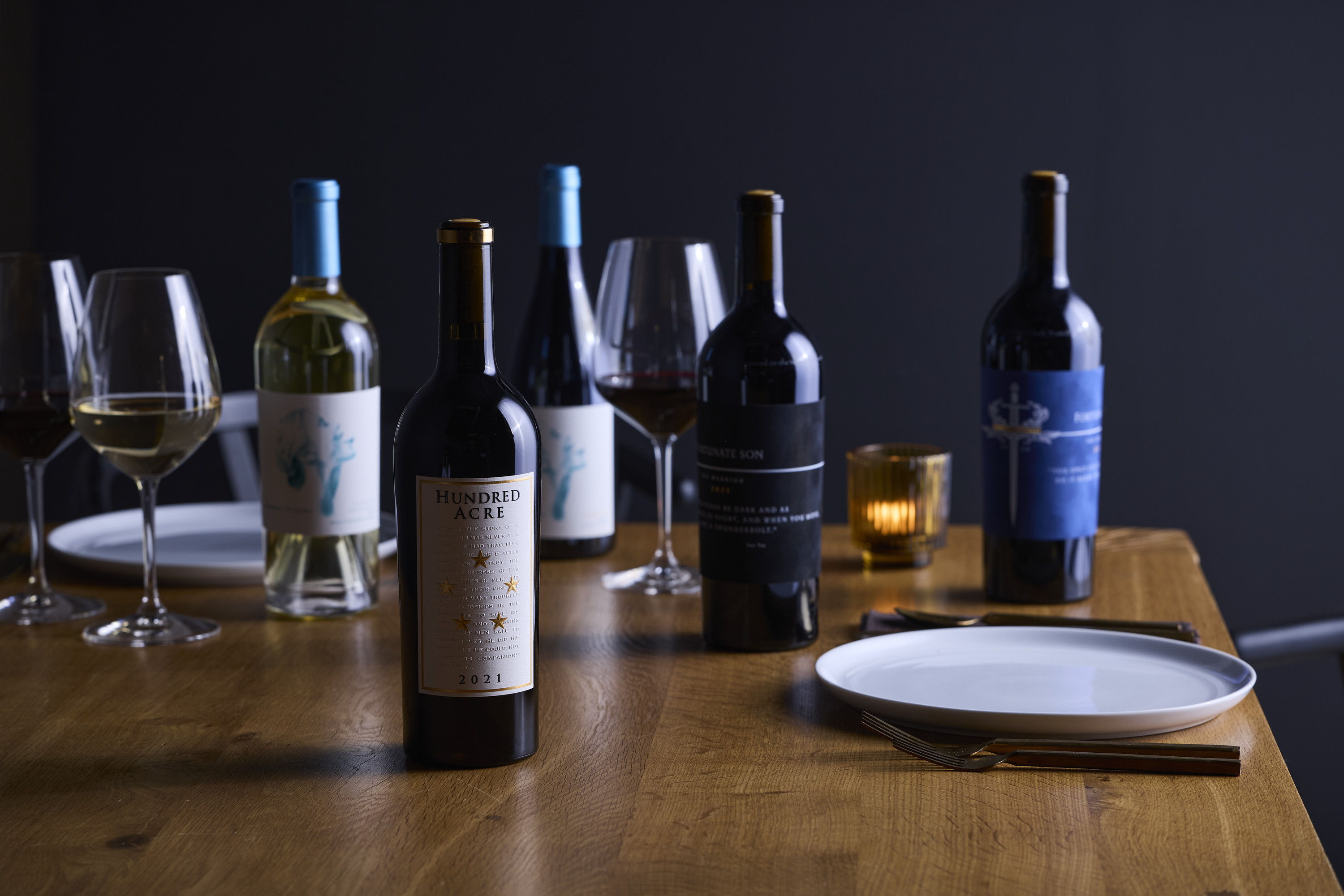 a table with wine bottles and glasses