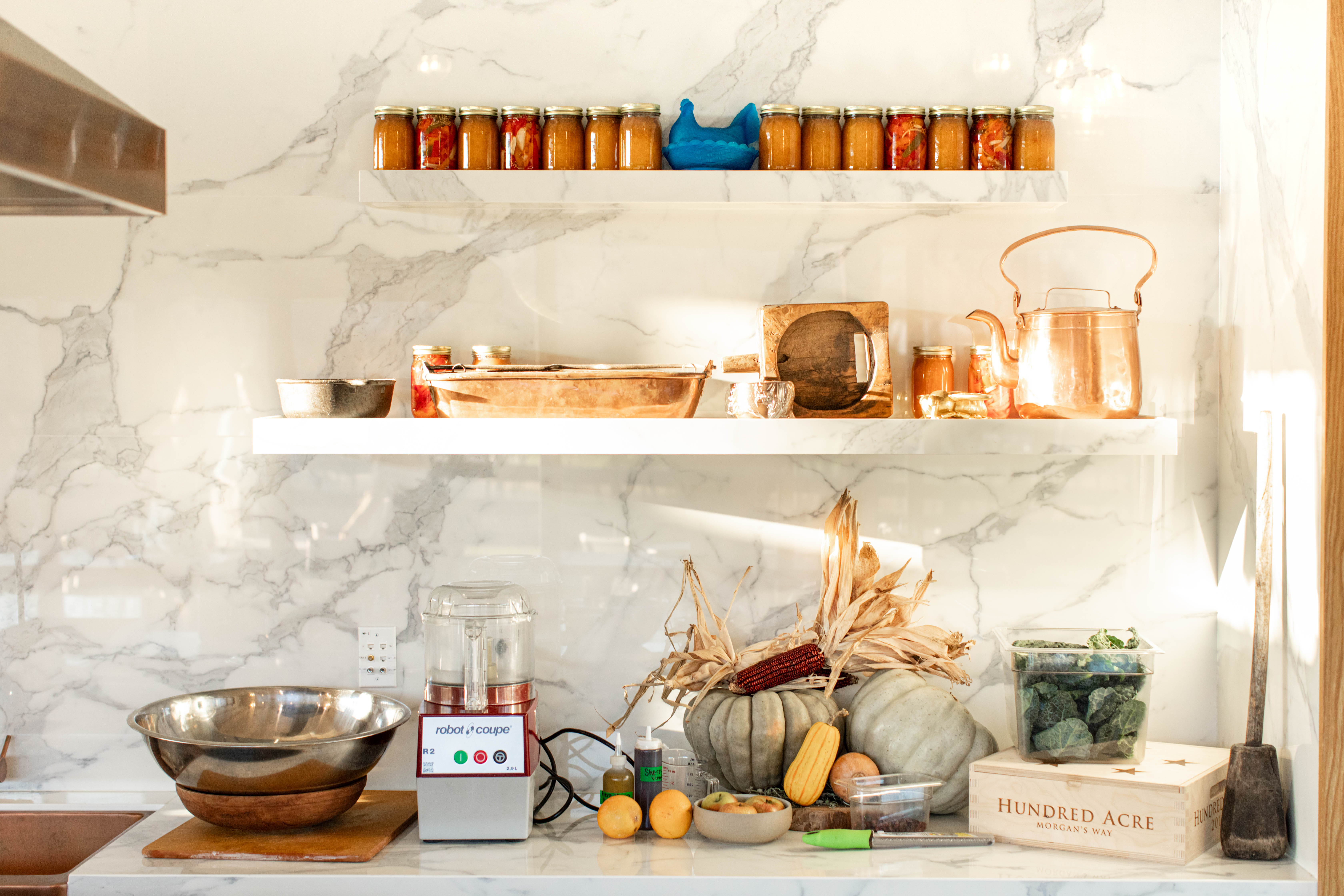 a kitchen counter with shelves and food