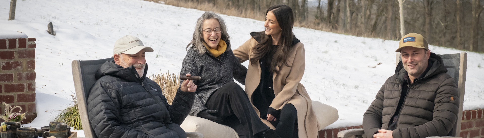 two women sitting on a couch in the snow