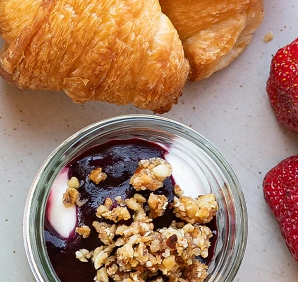 a croissant and fruit on a plate