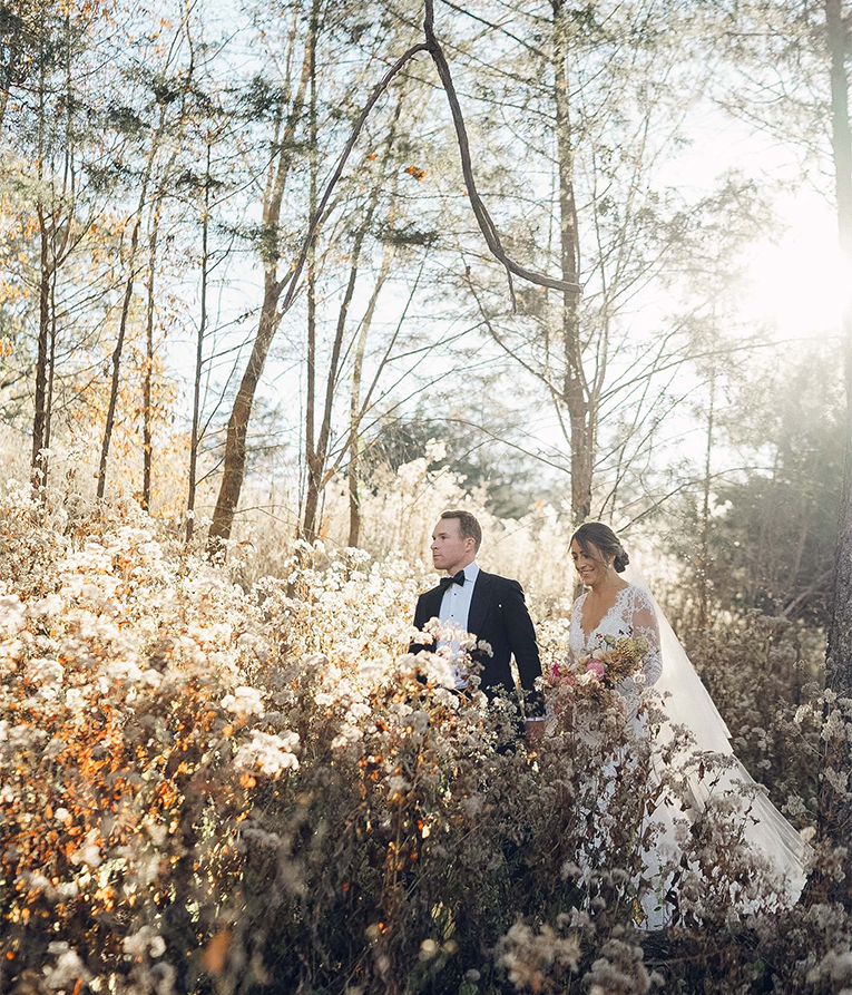 a man and woman in a field of flowers