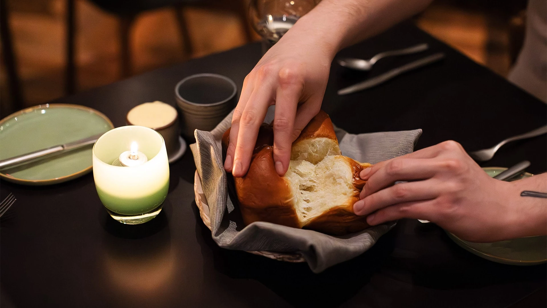 a person's hands touching a piece of bread