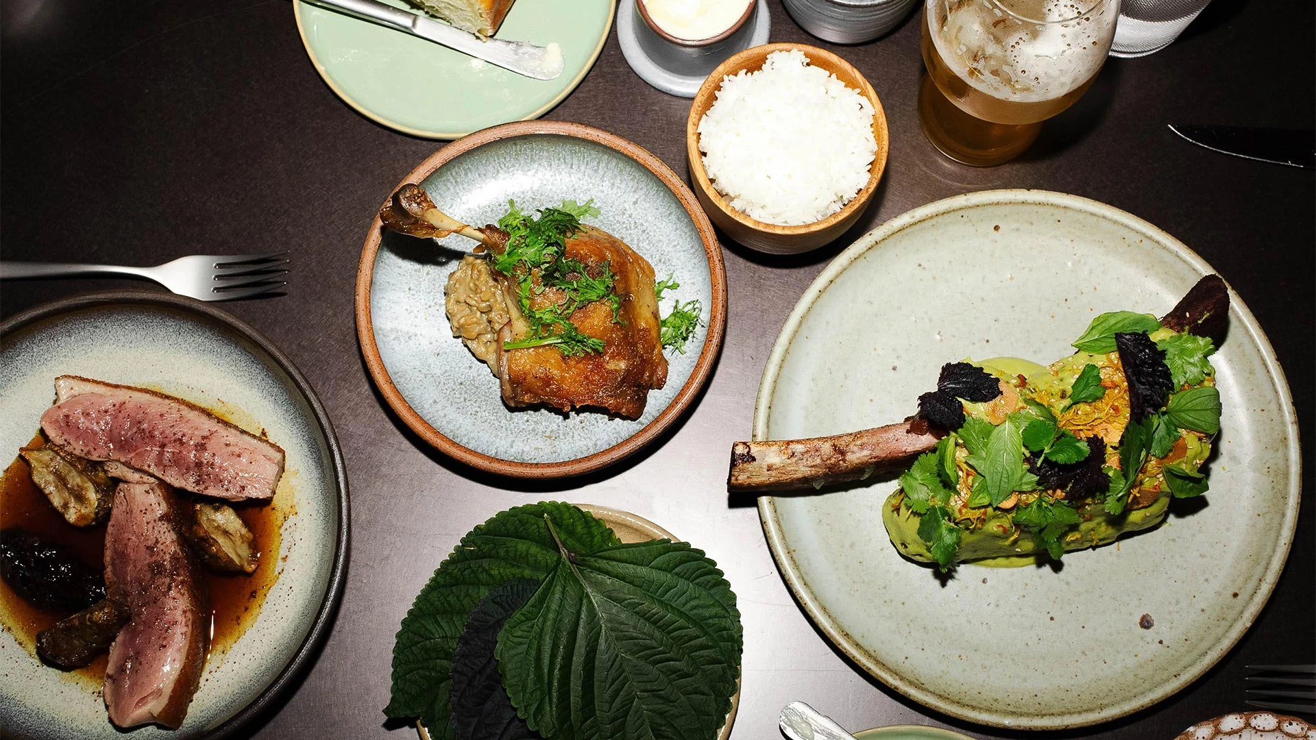 a table with plates of food and drinks